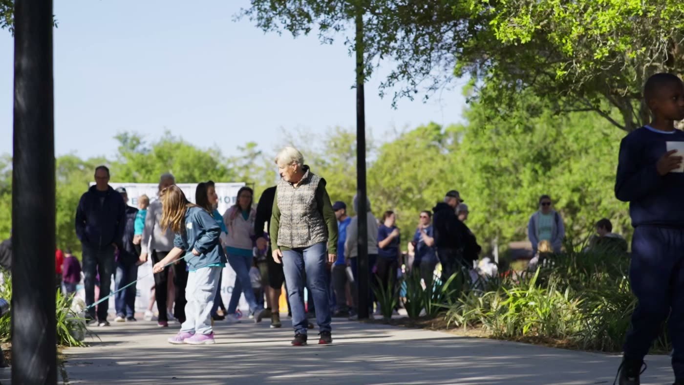Neighbors of all ages gathered outdoors for a community walk supporting life in Central Florida.