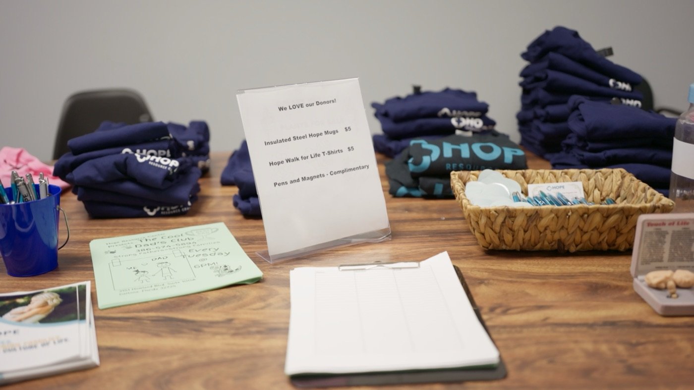 A Hope Resource Center fundraising table with donor merchandise