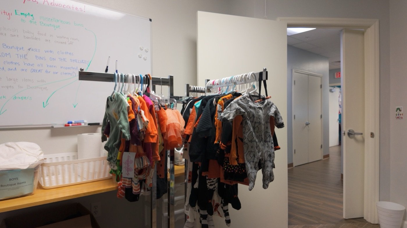 The Hope Resource Center material-resource room with racks of baby clothes and supplies